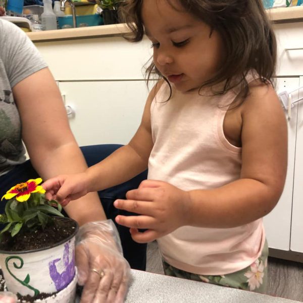 Bumblebees 2 Class Student helping to plant a flower